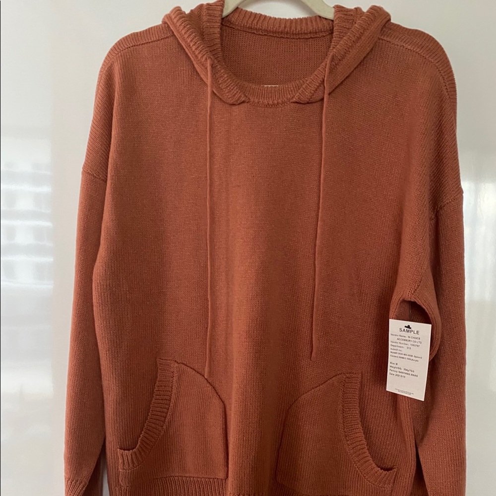 Brand new sweater with a hoodie and front pockets